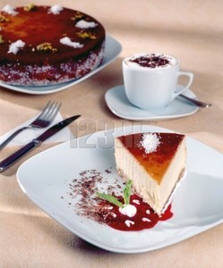 Cheesecake and cappuccino with cocoa