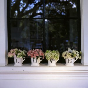 "l.o.v.e." mugs with flowers in them