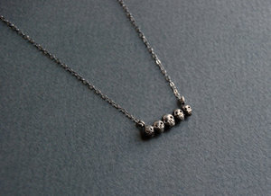 Tiny sterling silver skull necklace