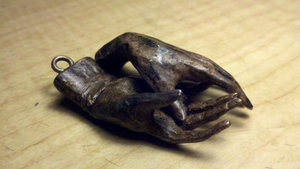 small bronze hands with bronze screw eyes