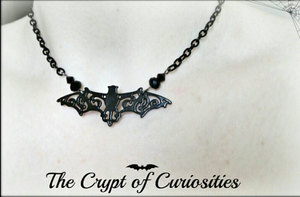 Gothic black filigree black crystal bat necklace.