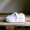 white sneakers on the platform